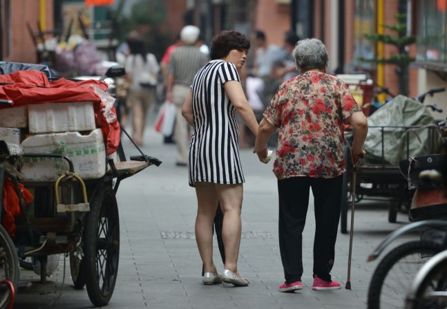 JULY 2 - SHANGHAI, CHINA: A mother and daughter walk together on July 1. <br /><a href="http://cnn.com/2013/07/02/world/asia/china-elderly-law/index.html?hpt=hp_c3">A new national law</a> introduced this week requires the offspring of parents older than 60 to visit their parents "frequently" and make sure their financial and spiritual needs are met. A third of China's population will be classed as elderly by 2050, <a href="http://cnn.com/2013/07/02/world/asia/china-elderly-law/index.html?hpt=hp_c3">according to Xinhua.</a>