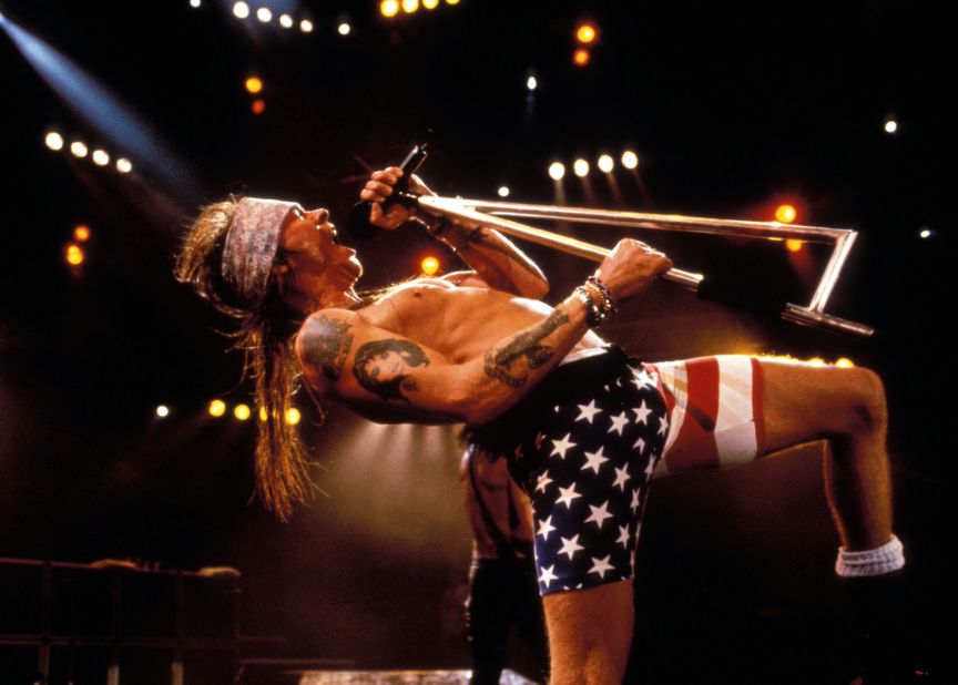 Axl Rose rocks out in flag biker shorts at a '90s Guns N' Roses show.