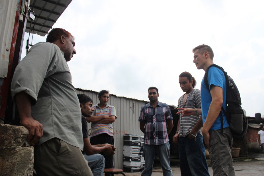 Cosmo Beatson (far right), executive director of Vision First, a refugee aid organization, gives a pep talk to a group of Bangladeshi refugees in the slum village of Ping Che on June 25, 2013. "When it dawns on refugees what they're stuck in, they're in shock," he says.