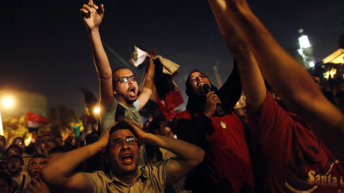 Protesters react after Morsy's speech in a street leading to the presidential palace in Cairo early on July 3. Morsy's angry opponents met head-on overnight with his supporters at Cairo University, leaving 23 people dead. 