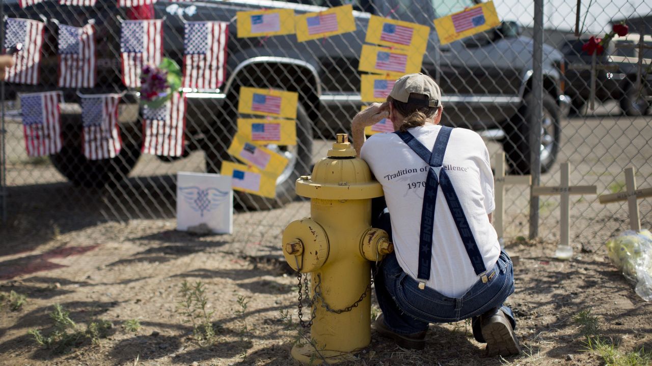 Stephen Grady reads some of the notes left at the Granite Mountain Interagency Hotshot Crew fire station in Prescott on Tuesday, July 2.