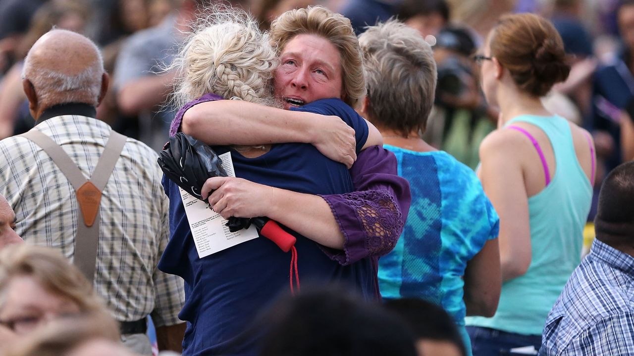 Family members of victims hug as they arrive at a vigil at Prescott High School on July 2. <a href="http://www.cnn.com/2013/07/02/us/gallery/hot-shot-victims/index.html">The elite team members' deaths</a> on Sunday, June 30, marked the deadliest day for U.S. firefighters since the 9/11 attacks.