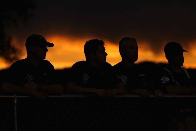 JULY 2 - PRESCOTT, U.S.: People attend a candle lit vigil in honor of the <a href="http://cnn.com/interactive/2013/07/us/yarnell-fire/index.html">19 fallen firefighters</a> who died battling a <a href="http://cnn.com/2013/07/03/us/arizona-fire/index.html">fast-moving wildfire</a> near Yarnell, Arizona. The region has been suffering from an extreme drought, and the winds whipping through the mountains can blow embers into new patches of woodland and mesquite grass.