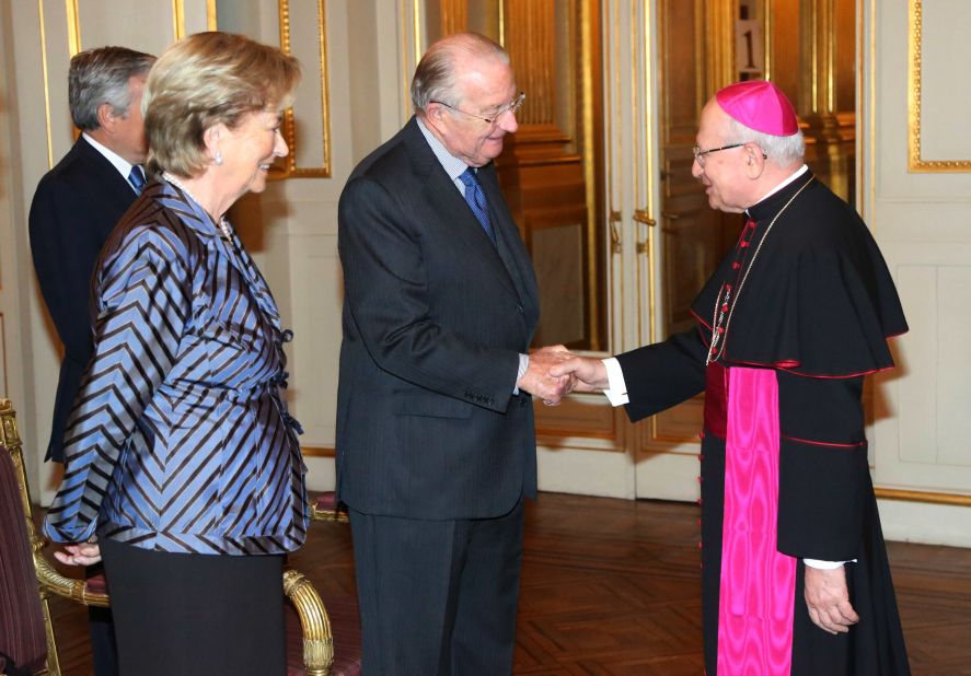 King Albert II shakes hands with Giacinto Berloco, the Vatican's prelate to Belgium and Luxembourg, while he and Queen Paola attend a reception at the Palais de Bruxelles on January 9 in Brussels.