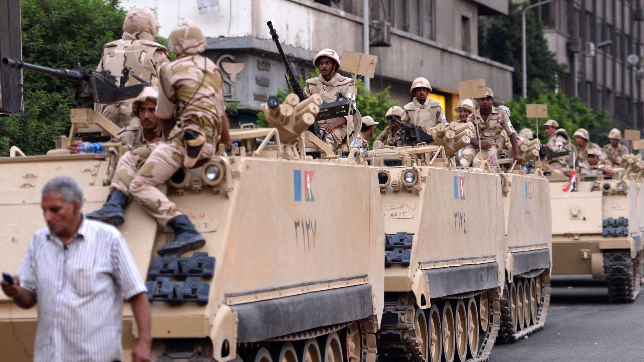 Egyptian army soldiers sit on top of armoured personnel carriers (APC) in Cairo on July 3, 2013 after the army deployed dozens of armoured vehicles near gathering of Islamist President Mohamed Morsi's supporters. A top aide to Egypt's President Mohamed Morsi slammed what he called a "military coup" as an army ultimatum passed and the security forces slapped a travel ban on the Islamist leader. AFP PHOTO/KHALED DESOUKIKHALED DESOUKI/AFP/Getty Images