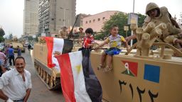 Egyptian children hold national flags as they pose for pictures near army soldiers on an armoured personnel carrier (APC) in a Cairo street on July 3, 2013 after the Egyptian army deployed dozens of armoured vehicles near gathering of Islamist President Mohamed Morsi's supporters. Opposition leader Mohamed ElBaradei and the heads of the Coptic Church and Al-Azhar -- Sunni Islam's highest seat of learning -- will unveil an army roadmap for Egypt's future after President Mohamed Morsi, state television said. AFP PHOTO/KHALED DESOUKIKHALED DESOUKI/AFP/Getty Images