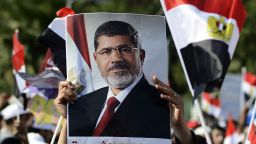 A supporter of Islamist Egyptian President Mohamed Morsi holds up his image during a rally outside Cairo University on June 2, 2013. A top Muslim Brotherhood leader urged Egyptians to stand ready to sacrifice their lives to prevent a coup, after the army gave Islamist President Mohamed Morsi and his opponents until July 3 to resolve their differences or face intervention. 