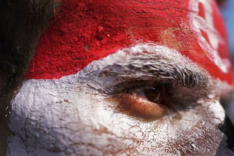 A man with his face painted the colors of the Egyptian flag looks out as thousands of protesters gather on July 3 in Tahrir Square.