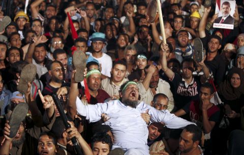 Members of the Muslim Brotherhood and Morsy supporters react at the Raba El-Adwyia mosque square on July 3 after the Egyptian Army's statement was announced on state TV.