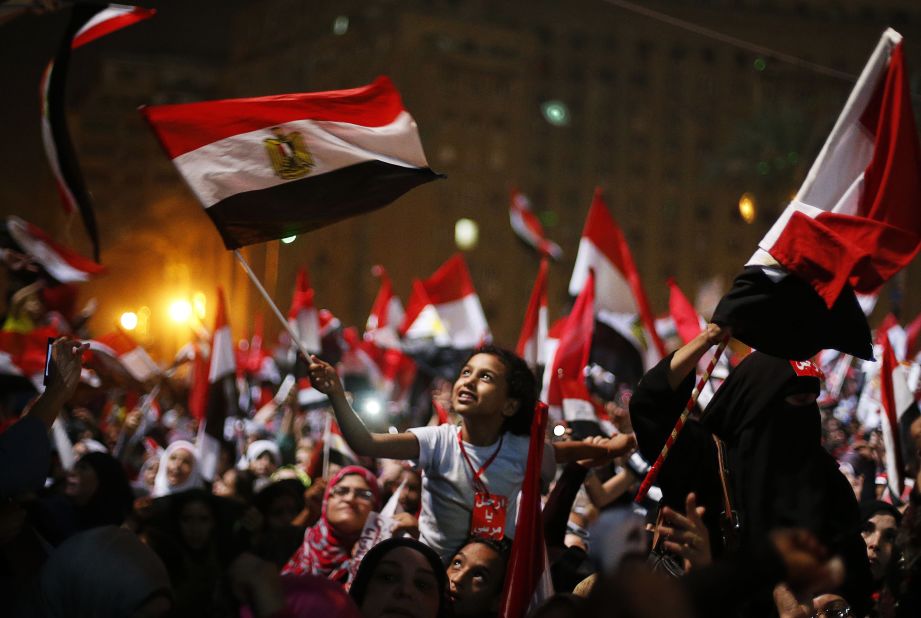 Anti-Morsy protesters wave flags in Tahrir Square on July 3.