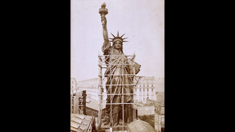 The statue, designed by sculptor Frederic Auguste Bartholdi, towers over Paris rooftops during construction in 1884. It was a gift from the people of France to commemorate 100 years of Franco-American friendship as well as the centennial of America's independence.