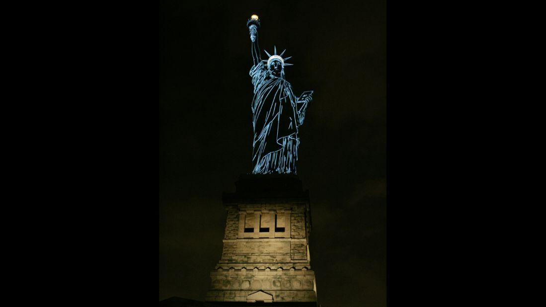 The Statue of Liberty is lit to show the contours of the sculpture in 2006, during a special show by French champagne maker Moet & Chandon.