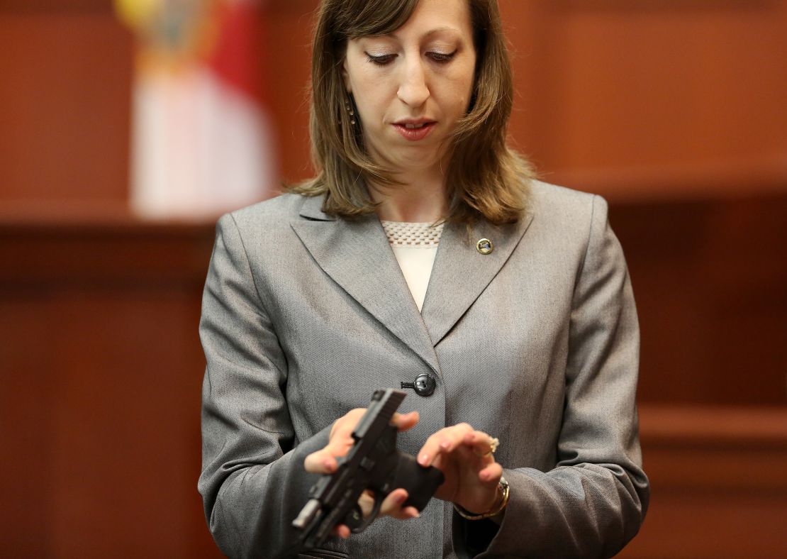 Firearms analyst Amy Siewert holds George Zimmerman's gun during his trial.