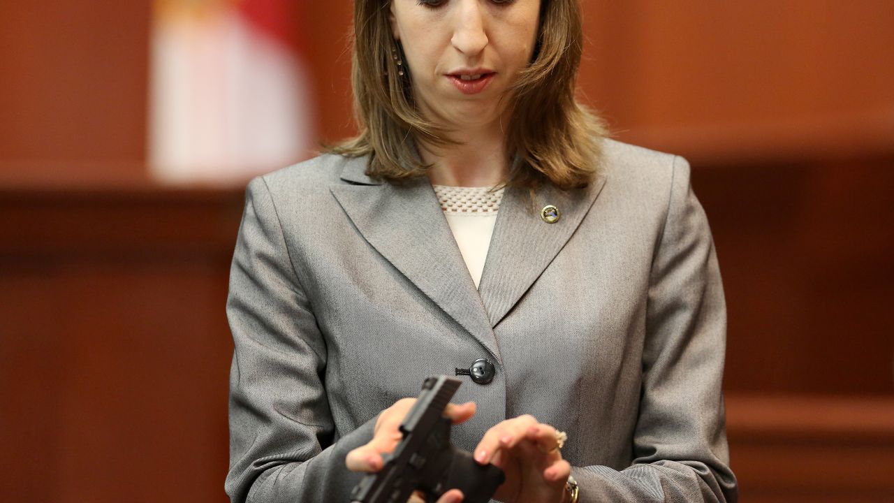 Firearms analyst Amy Siewert holds George Zimmerman's gun during his trial.
