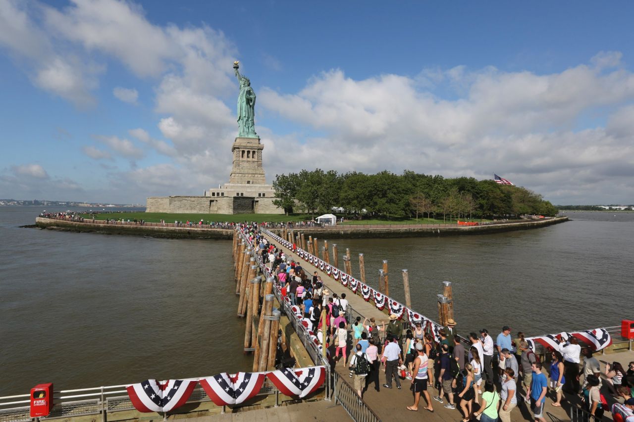 Visitors disembark from a ferry in July 2013. It was the first day the attraction reopened after suffering damage from Superstorm Sandy.