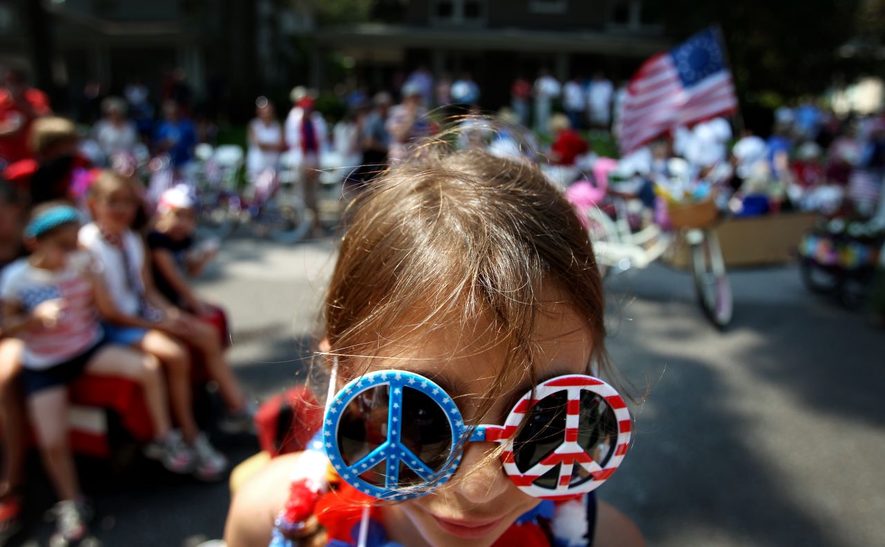 Neeley Mathes, 10, stands in front of the judges on Carr Avenue during the costume contest that follows the annual Central Gardens Fourth of July parade in Memphis, Tennessee.