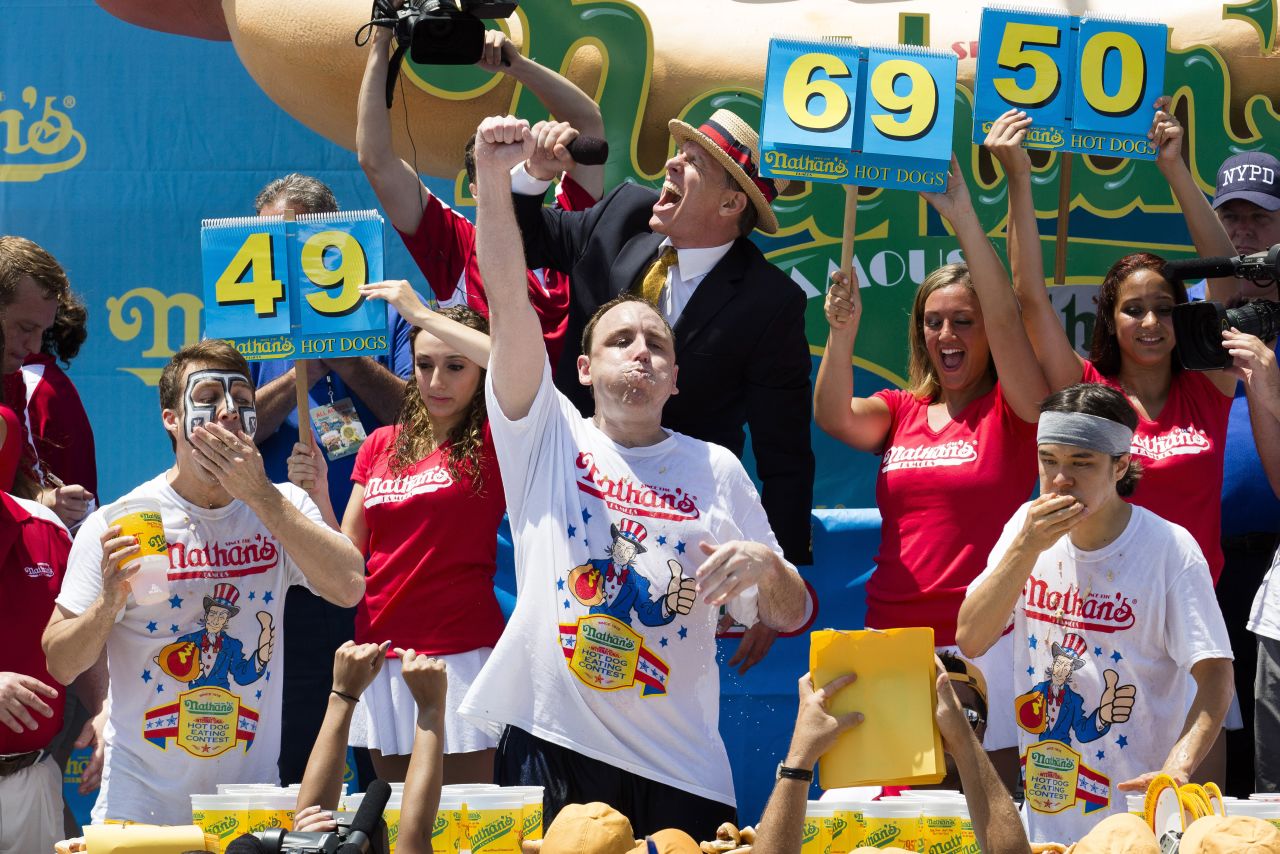 Perennial chomping champ Joey Chestnut, center, wins <a href="http://www.cnn.com/2013/07/04/us/ny-hot-dog-contest/index.html">New York's annual Independence Day hot dog eating competition</a> yet again with a total of 69 hot dogs and buns on Thursday at Coney Island in Brooklyn.