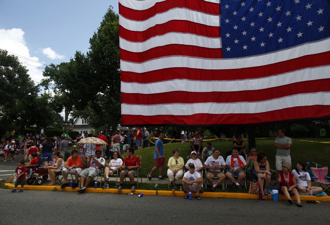 People line the streets to watch a Fourth of July parade in Ridgefield Park, New Jersey.