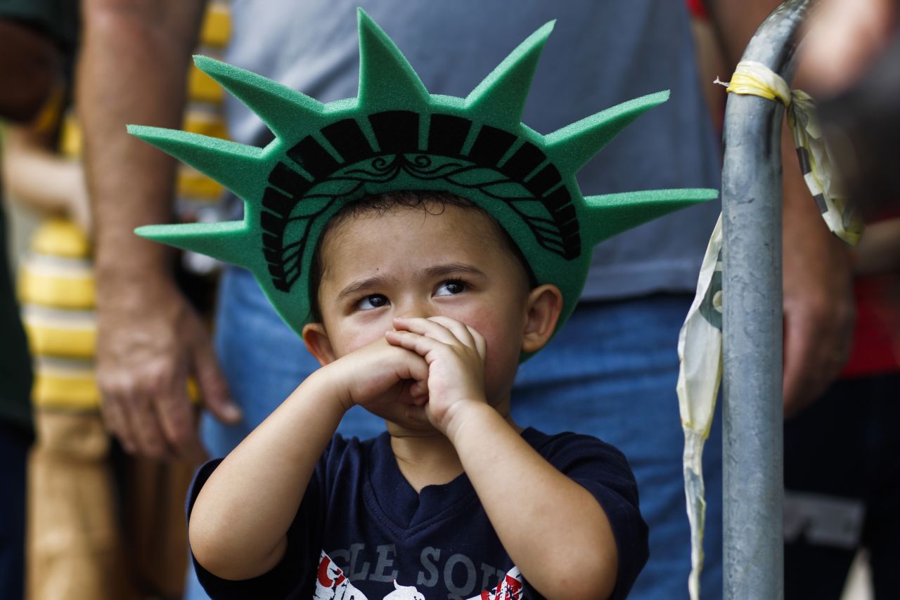 A child attends a ceremony to reopen the <a href="http://www.cnn.com/2013/07/03/us/gallery/statue-of-liberty/index.html">Statue of Liberty</a> to the public in New York on July 4.