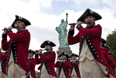 Members of the Old Guard attend the reopening ceremony of the Statue of Liberty, marking the first day it opened to the public after being shuttered by Superstorm Sandy in October.