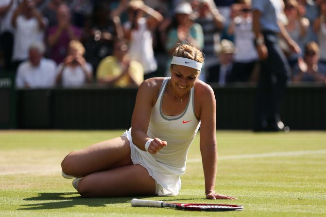 Sabine Lisicki falls to the Centre Court turf after completing an epic three-set semifinal win over Agnieszka Radwanska.