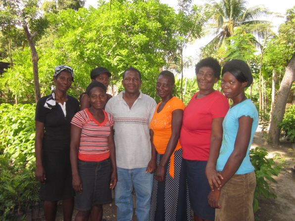 A loan from the SFA helped Haitian Romeus Mercilie (pictured second from right) to purchase new livestock and save money after hurricanes ruined her crops 