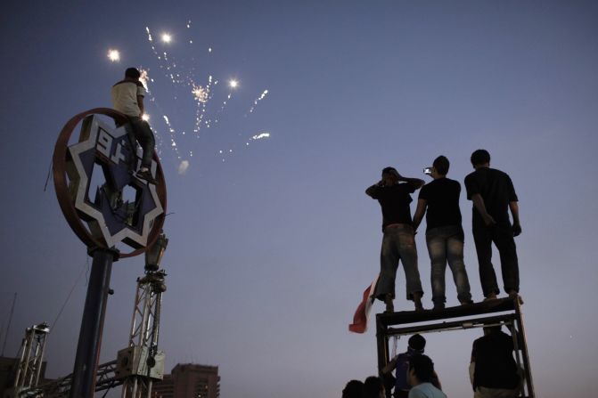 Egyptians watch fireworks in Tahrir Square on Thursday, July 4, the day after Morsy's ouster.