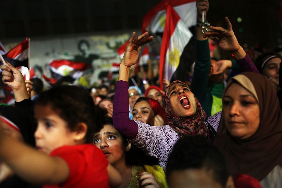 People dance and cheer in the streets of Cairo on July 4.