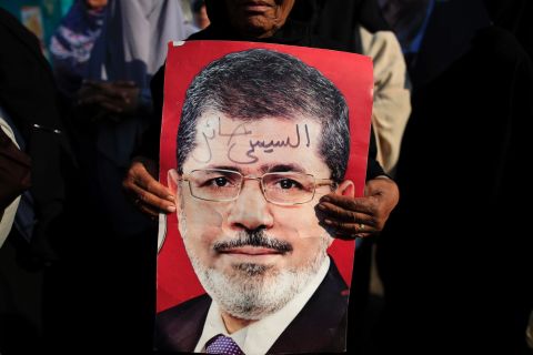 A Morsy supporter holds a poster of the deposed president during a July 4 rally in Nasr City.