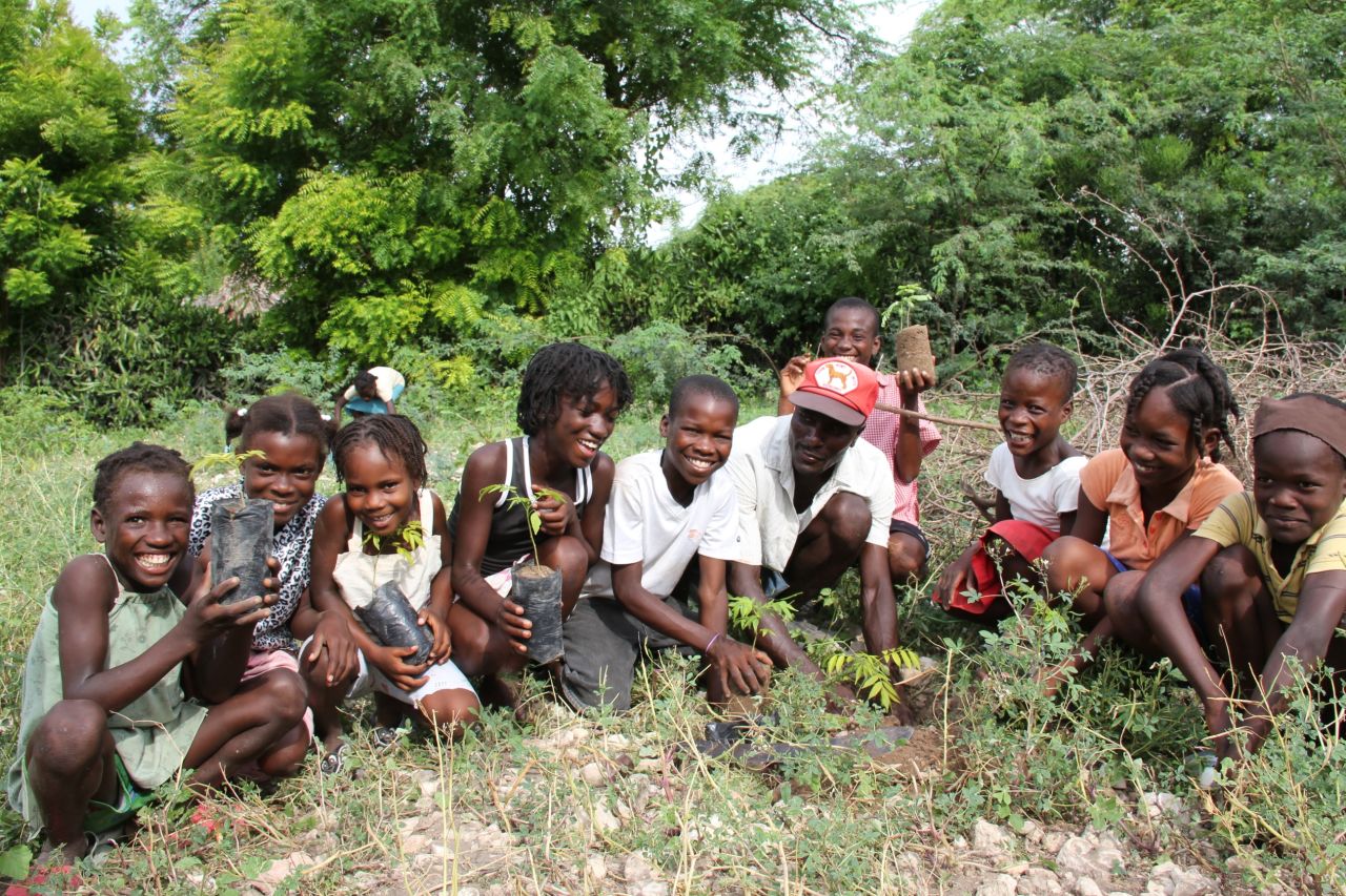 Children of the Smallholder Farmers Alliance members plant trees to help combat the extreme deforestation in Haiti