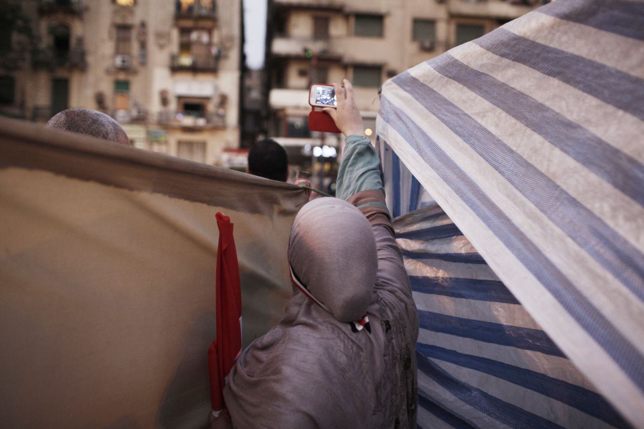 A woman uses a mobile phone to record the July 4 celebrations in Tahrir Square.