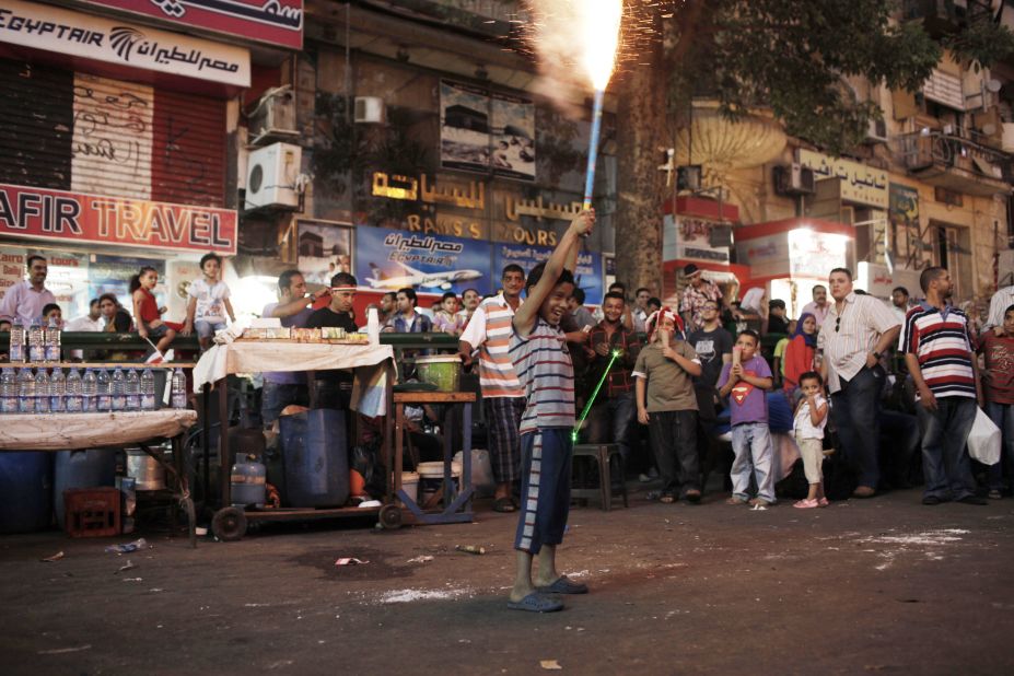 A young Egyptian boy shoots off fireworks during celebrations in Tahrir Square on July 4.