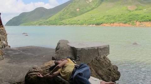 At the northeast tip of the village, a local man takes a nap. 