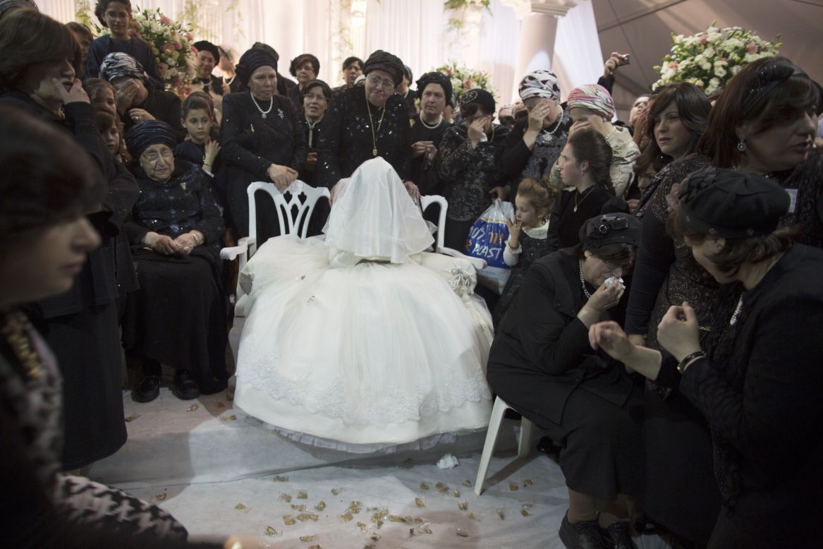 A Jewish bride is surrounded by relatives during her wedding to the great-grandson of the rabbi of the Tzanz Ultra-Orthodox Hasidic community in Netanya. 