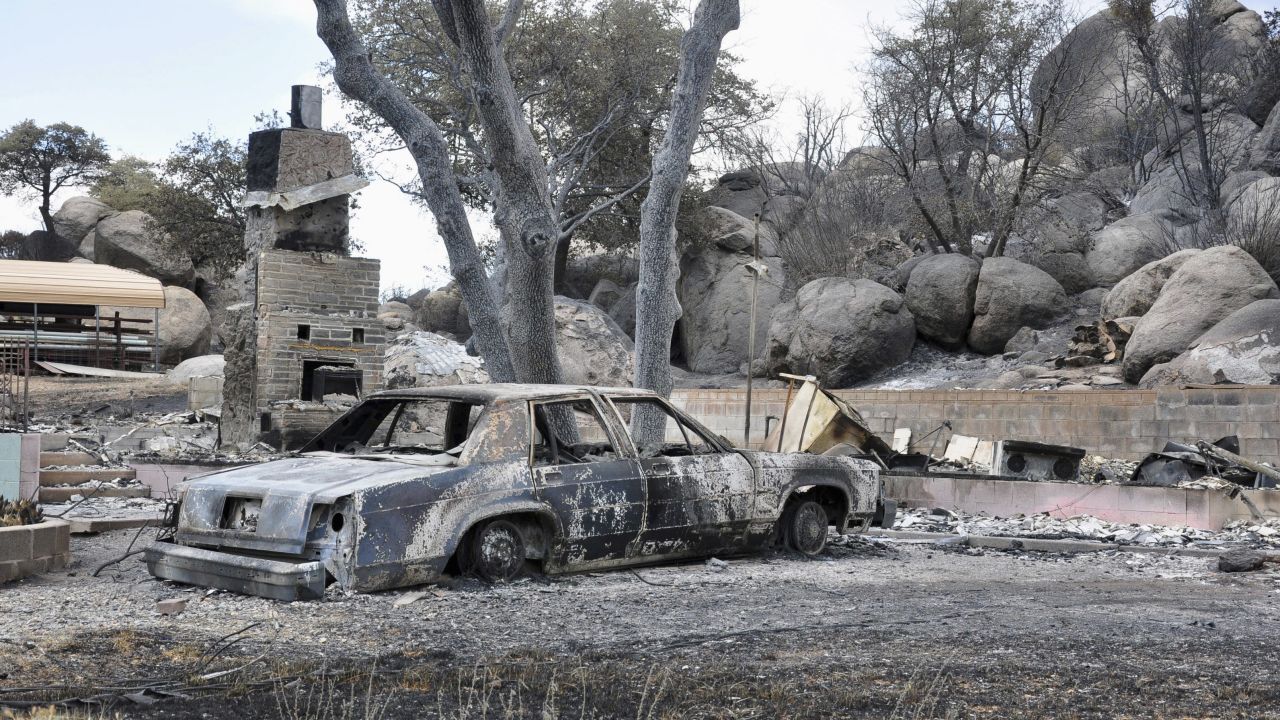 A deadly wildfire leaves behind little but a burned-out car and the remains of a house in a Yarnell, Arizona, neighborhood on Wednesday, July 3. The fire started a week ago near Yarnell, apparently because of lightning strikes. <a href="http://www.cnn.com/interactive/2013/07/us/yarnell-fire/index.html" target="_blank">Nineteen firefighters were killed</a> Sunday, June 30, battling the blaze northwest of Phoenix. 