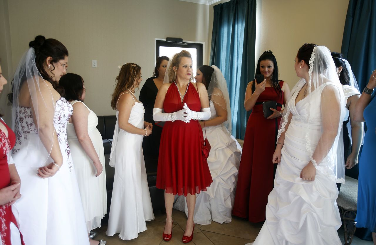 A dozen brides wait to be married during a ceremony for a radio station contest at the Little Chapel of the Flowers on December 12, 2012, in Las Vegas.