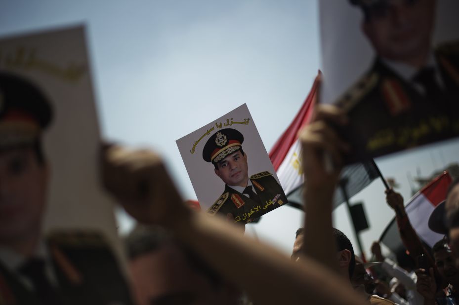 Egyptians hold portraits of Gen. Abdel-Fatah El-Sisi reading "Come down, Sisi" as they gather in Cairo's landmark Tahrir Square on July 5.
