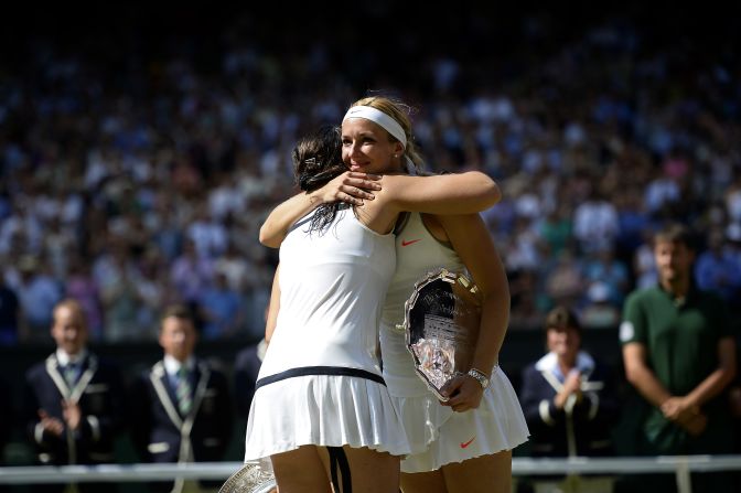 Bartoli and Lisicki share a sporting embrace during the awards ceremony.