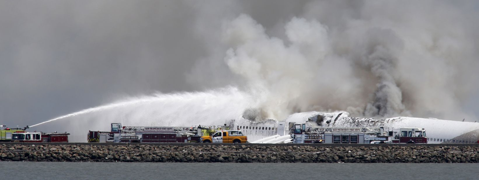 Fire crews work at the crash site at San Francisco International Airport on July 6.