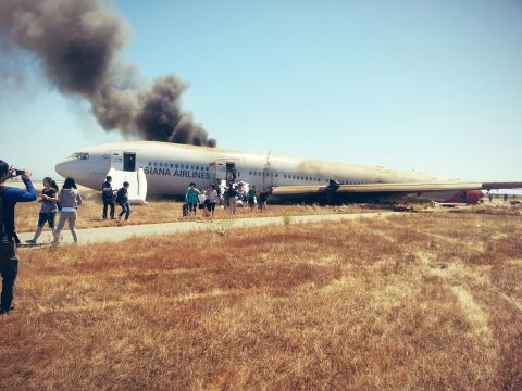 David Eun, a passenger on Asiana Airlines Flight 214, posted this image to Path.com along with the message, "I just crash landed at SFO. Tail ripped off. Most everyone seems fine, I'm ok. Surreal..." It was one of the first photographs taken after the crash.