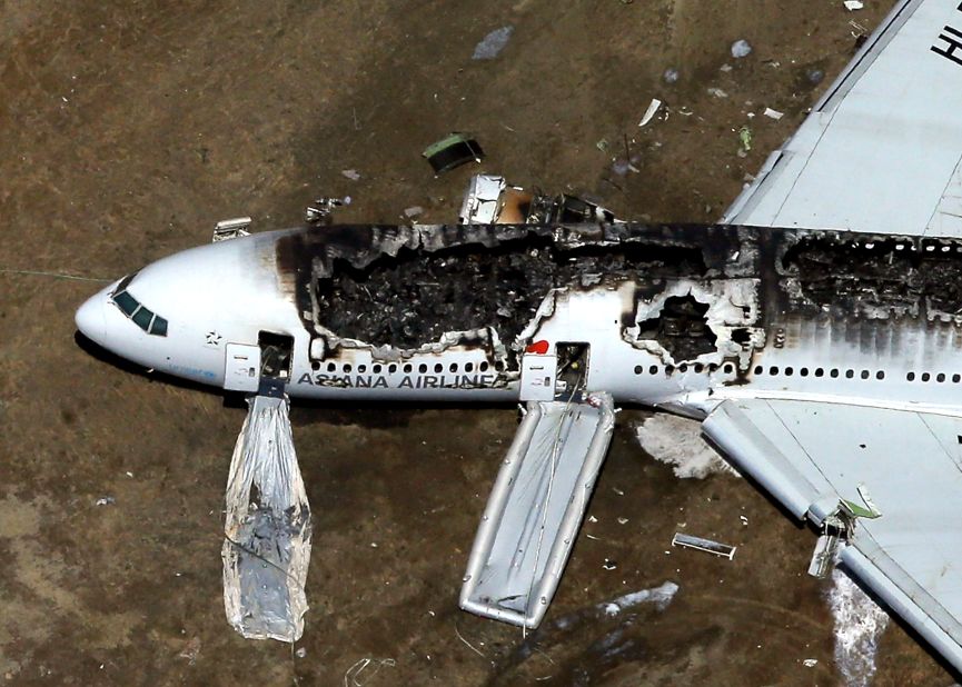 The burned-out plane remains on the runway on July 6. Passengers and crew members escaped down the emergency inflatable slides.