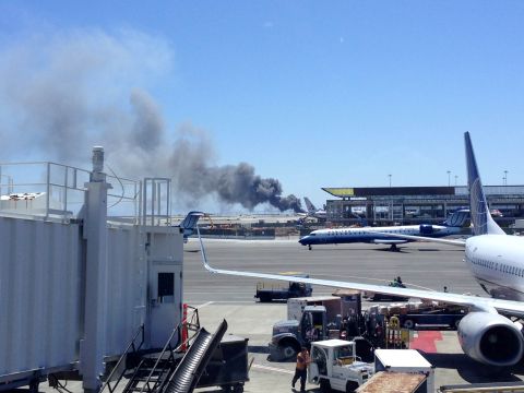 Smoke rises from the crash site on July 6 at the airport in San Francisco.
