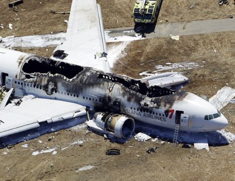 Asiana Airlines Flight 214 remains on the runway on July 6.