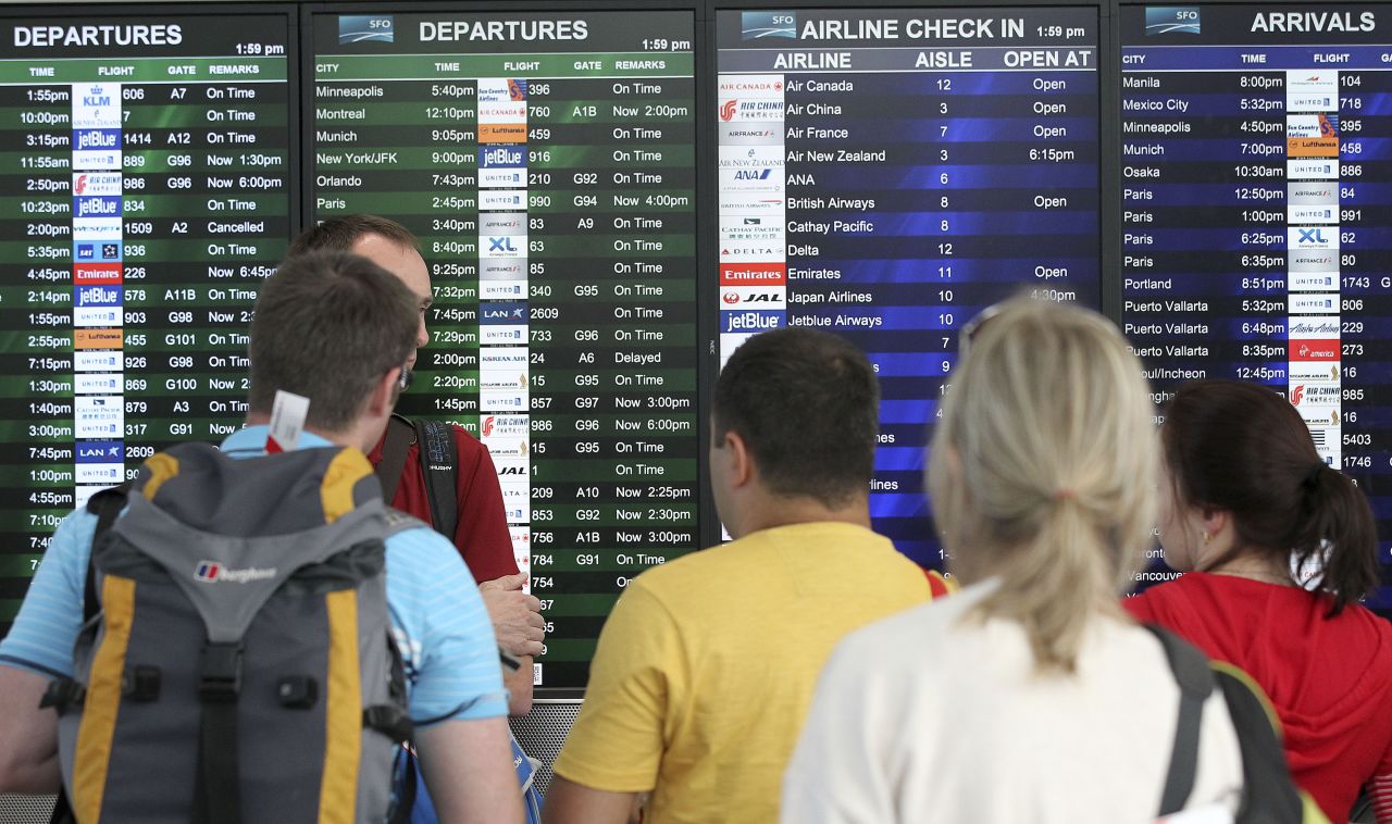Travelers at San Francisco International Airport look at the departures and arrivals board after Asiana Flight 214 crashed on July 6. The airport, located 12 miles south of downtown San Francisco, is California's second busiest, behind Los Angeles International.