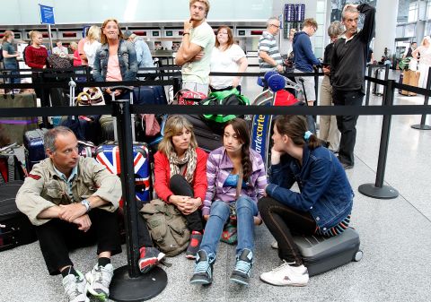 Passengers wait for the British Airways counter to reopen at San Francisco International Airport on July 6.