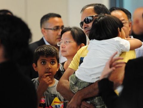 People are escorted from the Reflection Room at the San Francisco International Airport on July 6.