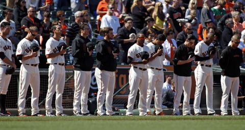 The San Francisco Giants observe a moment of silence for those killed and hurt in the crash before their baseball game on July 6 against the Los Angeles Dodgers at AT&T Park in San Francisco.