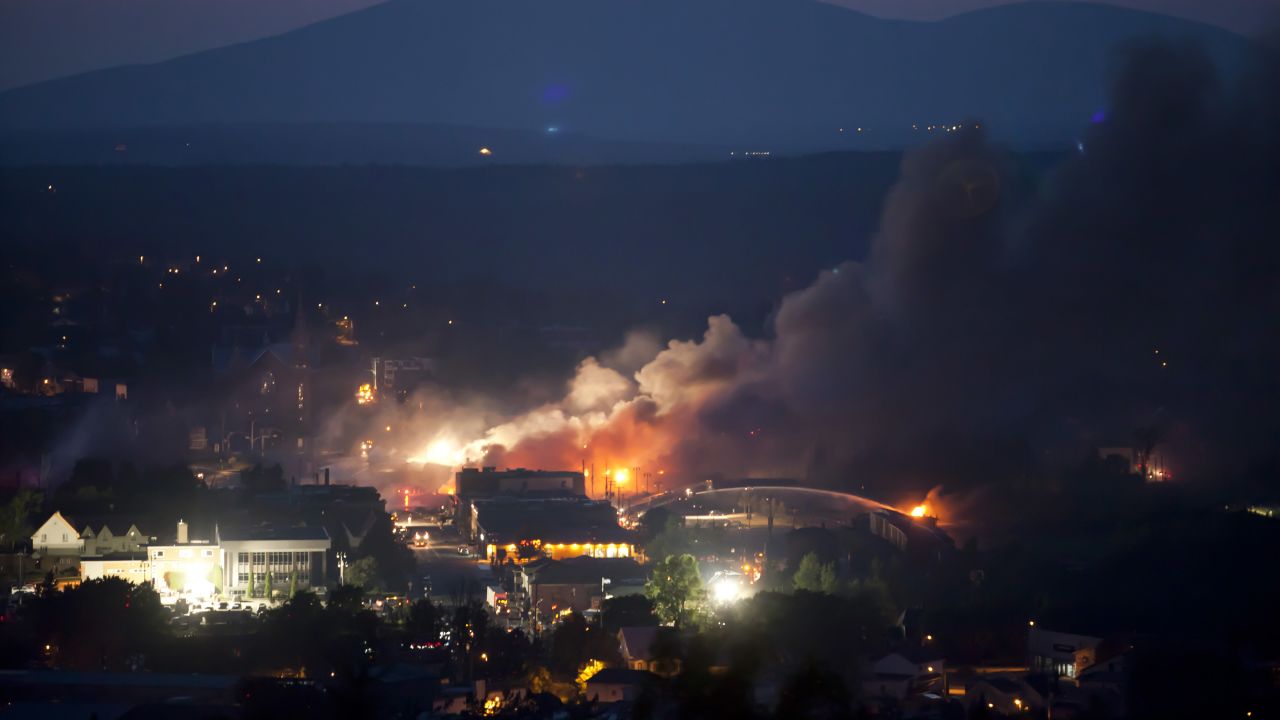 Firefighters battle fires in Lac-Megantic on July 6.