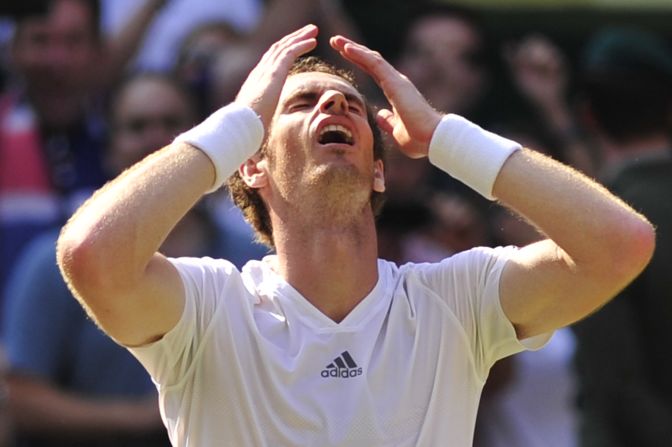 Murray celebrates after claiming the third set 6-4 to secure his first ever Wimbledon crown.