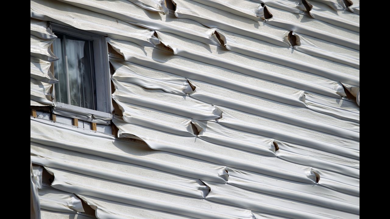 Melted siding on a home is seen near the scene of a train derailment in Lac Megantic, Quebec, July 7.